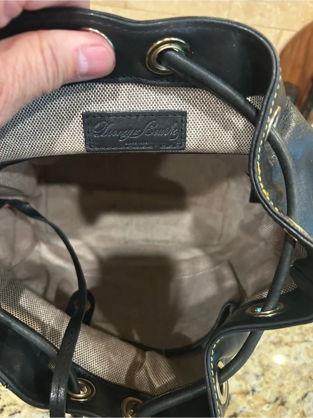 Dooney & Bourke Black Leather Drawstring Backpack with Yellow Stitching